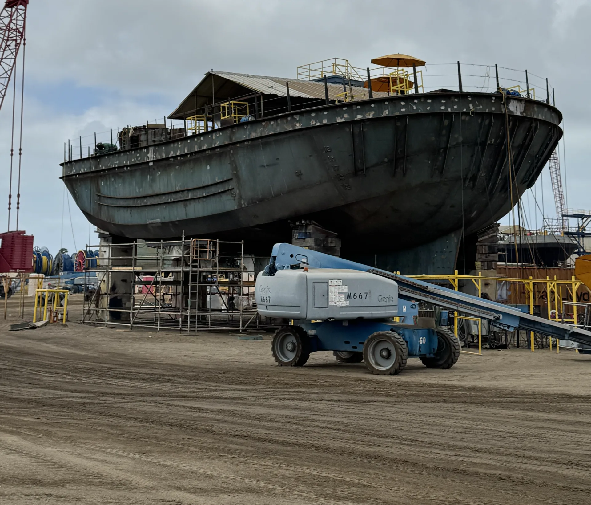 Bare steel hull under construction surrounded by scaffolding